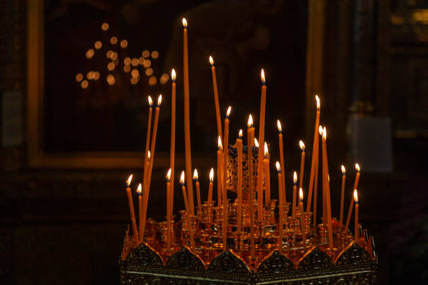 Lighted candles in a dark Orthodox church.