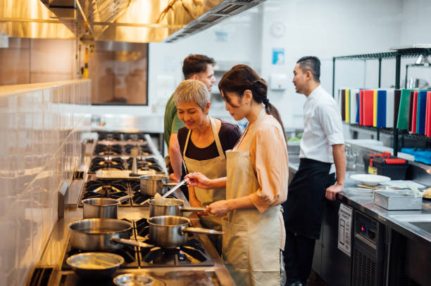 istock Global Gastronomy: Asian Female Students Uniting in Culinary Exploration 2112494788