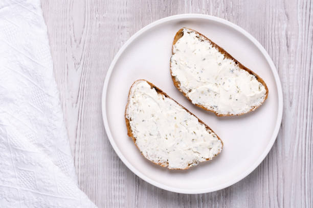 istock Sandwiches with soft curd cheese on a white wooden table 2112541210