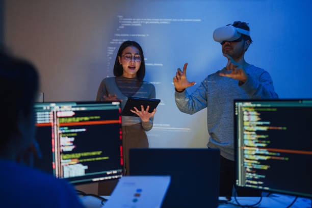 istock asian and Indian developer team brainstorming and presentation about virtual reality  with ai coding project at night in office 2112543896