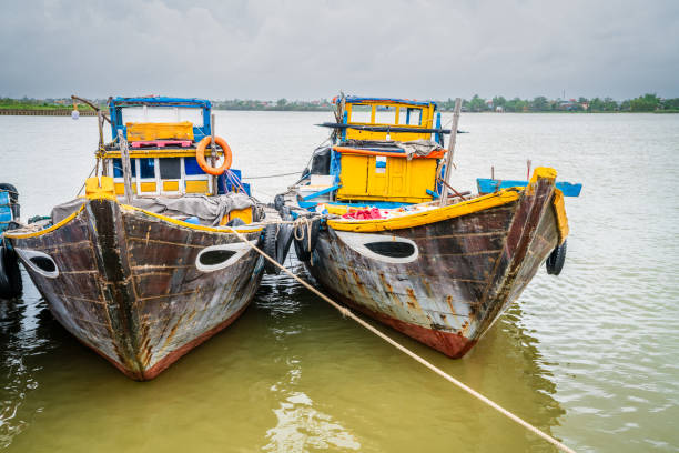 Mui Ne, Vietnam - April 22, 2018: Fishing village and traditional fishing boat with hundreds boats anchored in beautiful stream. This is  bay for boats avoid rainy season storms in Mui Ne, Vietnam