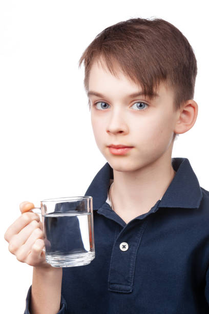 istock Boy Holding Cup of Water 2112558544