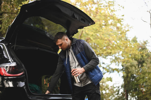 istock Young man preparing for a hiking tour. 2112561404