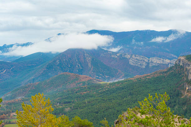 Vallcebre mountains, Berguedà province in Barcelona. Catalonia.Forest in Pyrenees with autumn colors and beautiful clouds.