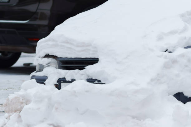 istock Frozen Reflections: Enveloped in Snow, a Car Braces Winters Embrace Beside a Stoic Parking Meter 2112617130