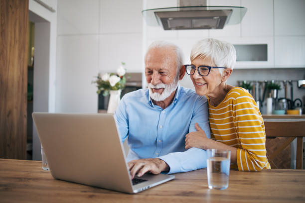 istock Shot of an affection senior couple using their laptop while relaxing at home 2112652970
