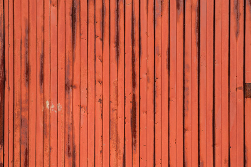Multicolored wooden background. Planks are painted with different colors, but weathered and partially peeled.