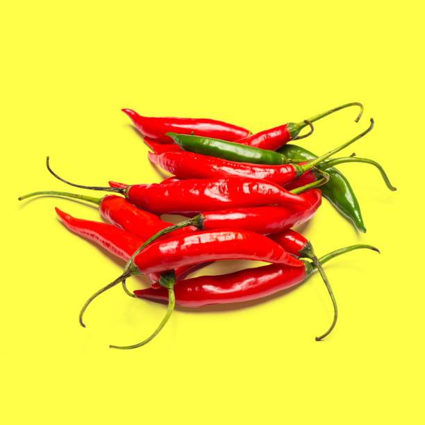 istock red peppers on colorful background 2112693406