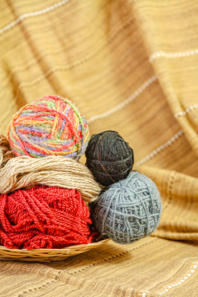 Polyester cords in rolls on a wooden background. Multi-colored cords for knitting bags and baskets.