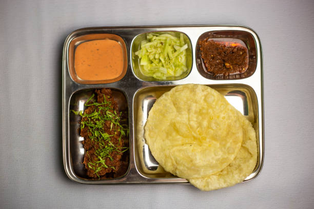istock Beef Chaap with Lucchi with chuntney, sauce and chilli dip served in thali platter isolated on background top view of bangladeshi food set menu 2112754816