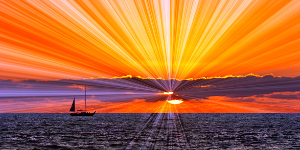 Colorful Image Of A Sailboat Sailing Along The Ocean Horizon With Orange Sunset Sky