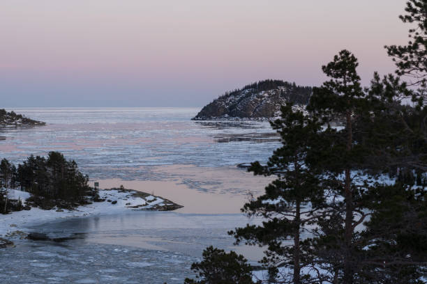 istock the view over frozen water on a mountain side with snow 2112775726