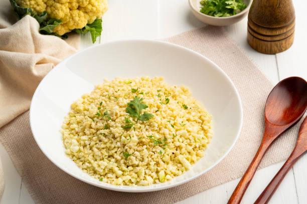 istock Cauliflower rice in white plate.Low carb diet. 2112782543