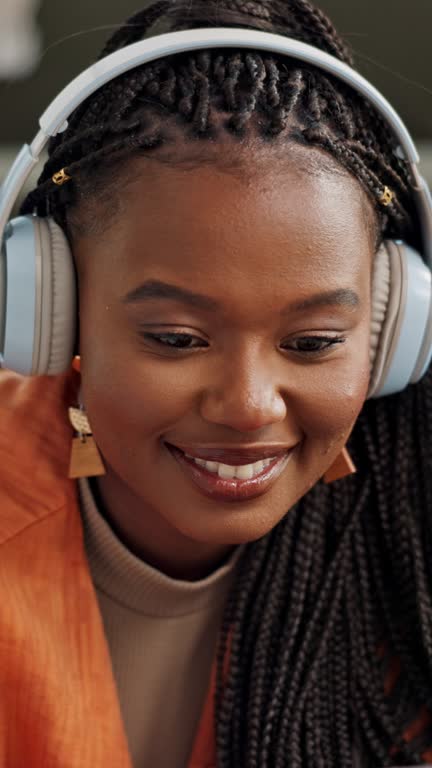 Music, headphones and black woman on laptop in home living room, listening to audio and sound to relax. Smile, radio and African person on computer streaming, hearing song and enjoy freedom on tech