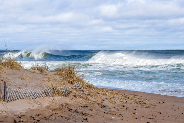 istock Ocean view with a fence in foreground and crashing waves 2112797968