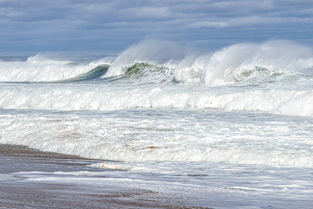 istock Ocean view with a fence in foreground and crashing waves 2112798184
