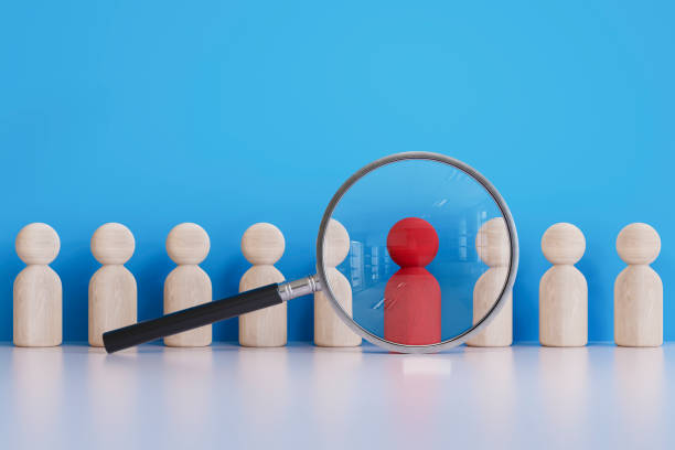Human resources, magnifying glass with pawns