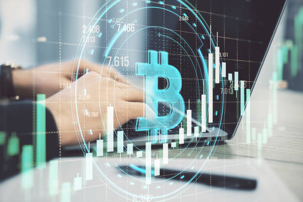 istock Close up of male hands using laptop with creative round bitcoin hologram on blurry grid background with forex chart. Online banking, cryptocurrency and finance concept. Double exposure. 2112824341