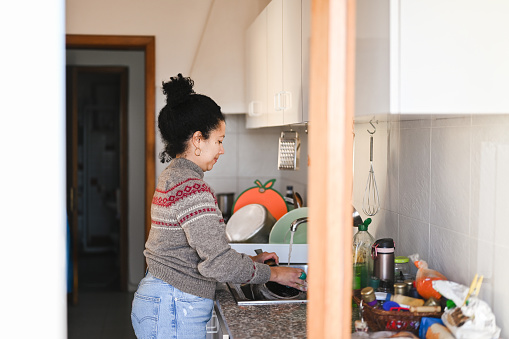 Woman working at home in kitchen.