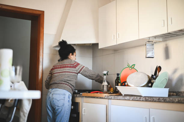 istock Housewife cleaning kitchen. 2112848235