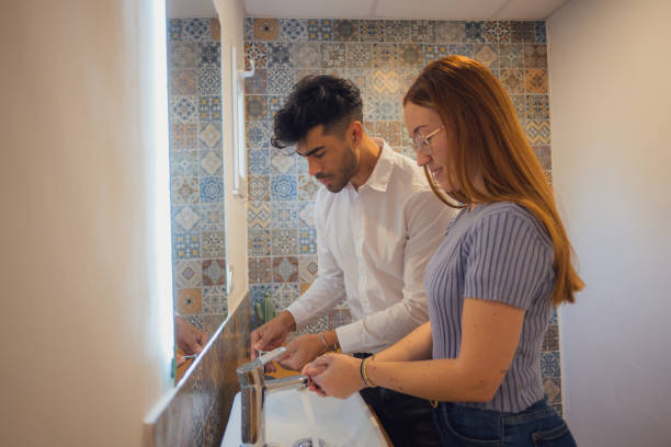istock Man and woman standing in a bathroom 2112850883