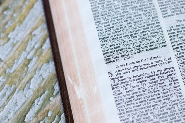 istock Jesus Christ heals on the Sabbath verses in open holy bible book 2112854588