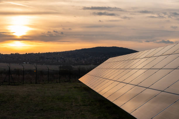 istock Solar panels in a solar power station at sunset 2112869549
