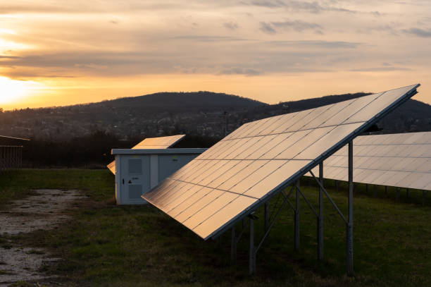 istock Solar panels with a transformer station in a solar power station at sunset 2112869829