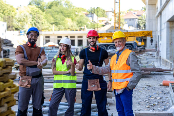 istock Portrait of a Group of Multi-Ethnic Construction Workers Smiling at the Camera After Successful Work. 2112875416