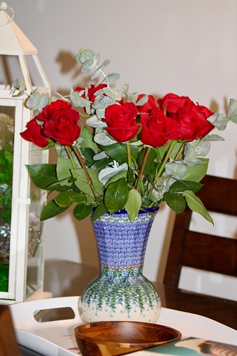 A bouquet of roses in a vase on a table.