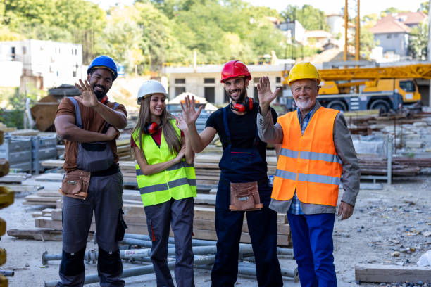 istock Portrait of a Group of Multi-Ethnic Construction Workers Smiling at the Camera After Successful Work. 2112889430