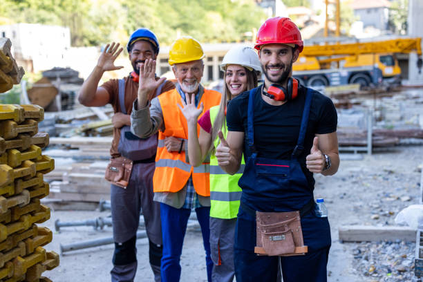 istock Portrait of a Group of Multi-Ethnic Construction Workers Smiling at the Camera After Successful Work. 2112890506