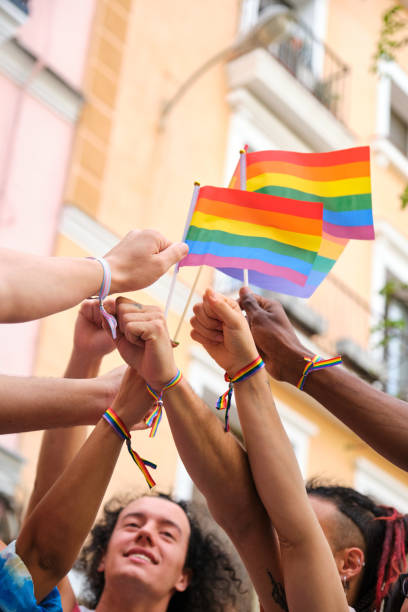istock A group of people holding rainbow flags and bracelets 2112925297