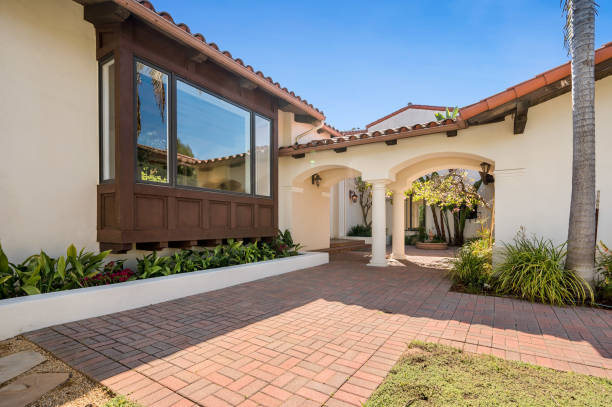istock a driveway with bricks on it, a large tree in front and a plant 2112939353