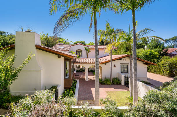 istock a house surrounded by palm trees and landscaping with a covered front porch 2112939877