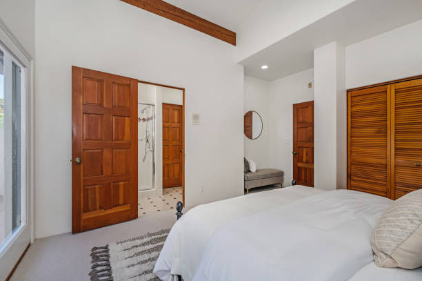 istock a bedroom that has a white bed with white pillows and pillows 2112940912