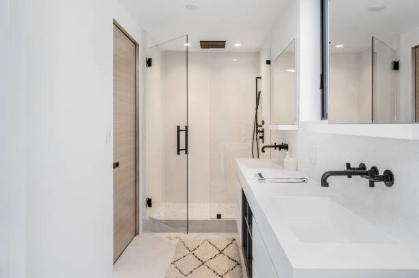 istock a white bathroom with large glass doors and sink area with wood paneling 2112941439