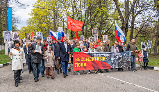 Zhukovsky,RUSSIA,MAY 9,2022: Immortal regiment on Victory Day the 9th of May, when people go column and carry banners with portraits of their relatives who participated in the great Patriotic war.