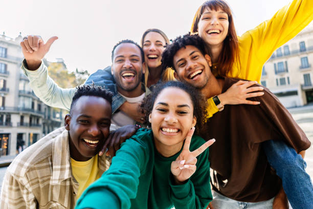 istock Diverse group of young students having fun taking selfie portrait together 2112989374