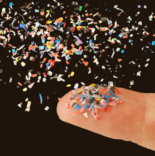 istock Close up of microplastic on finger concept of water plastic pollution and global warming on black background 2112996546