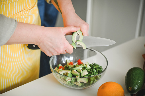 Woman preparing vegetable salad