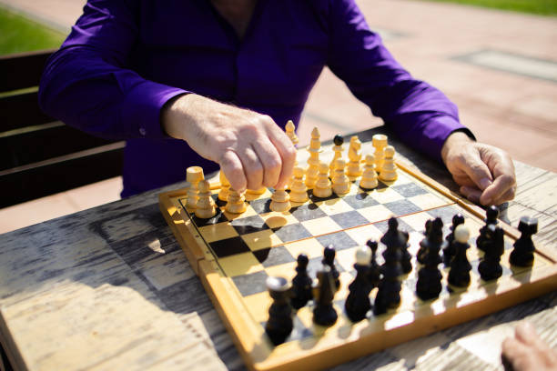Two Senior men playing chess in public park