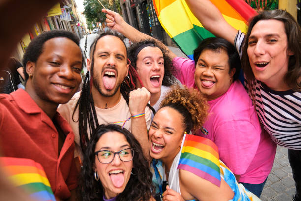 istock A group of LGBTQ people taking a selfie with rainbow flags during Pride Parade. 2113042901