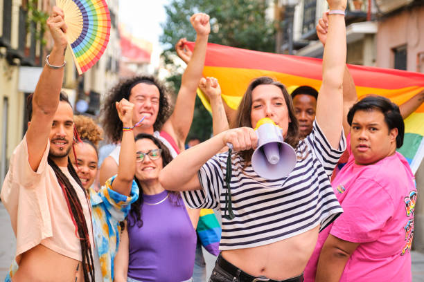 istock LGBTQ people with rainbow flags and a megaphone fighting for their rights. 2113056426