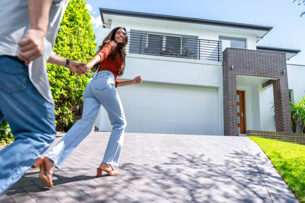 istock Couple joyfully running into their new home. 2113061092