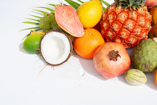 Summer mix of tropical fruits over white, close up