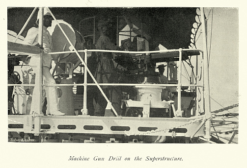 Vintage picture of Machine gun drill on HMS Magdala, Indian Navy Harbour Defence Force, Military History, 1890s, 19th Century. HMS Magdala was a Cerberus-class breastwork monitor of the Royal Navy, built specifically to serve as a coastal defence ship for the harbour of Bombay (now Mumbai) in the late 1860s