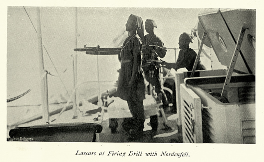 Vintage picture of Lascars firing Nordenfelt multiple-barrel organ gun on HMS Magdala, Indian Navy Harbour Defence Force, Military History, 1890s, 19th Century. HMS Magdala was a Cerberus-class breastwork monitor of the Royal Navy, built specifically to serve as a coastal defence ship for the harbour of Bombay (now Mumbai) in the late 1860s