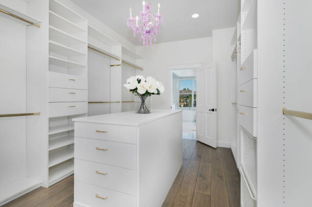 istock White closet with open shelves and a large countertop 2113095268