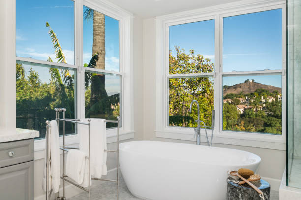 istock Spacious bathroom featuring a large bathtub and exterior windows 2113096307